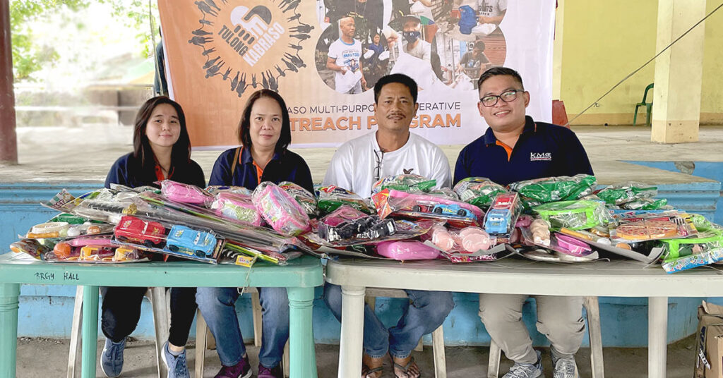 Members of KMC conducting an outreach program giving away toys