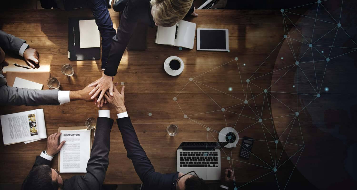 Overhead perspective of business professionals joining hands