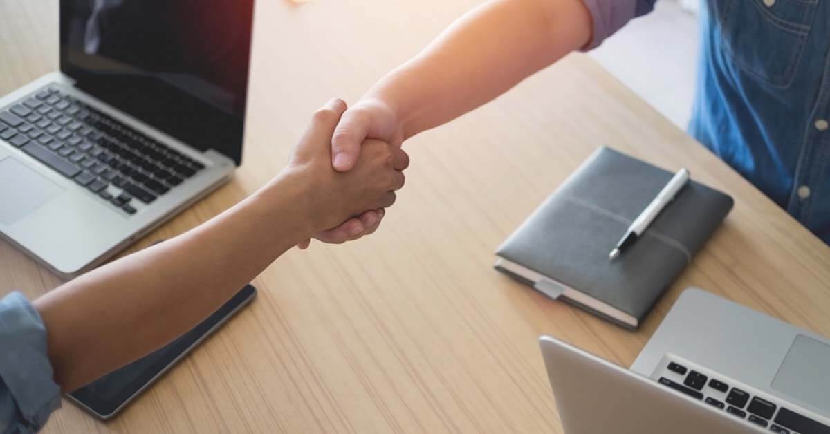 Service contractor and client shaking hands as a sign of the deal