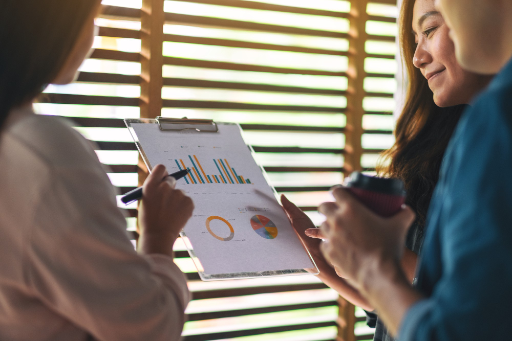 Three employees of a manpower service provider company discussing the rate flexibility and scalability of a business that offers workforce solutions under four key sectors such as Agri-Manufacturing, Mining, Renewable Energy, and Facility Management