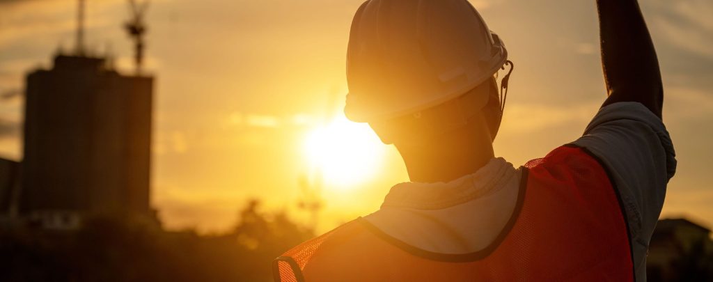 male laborer working under the heat of the sun facing the horizon